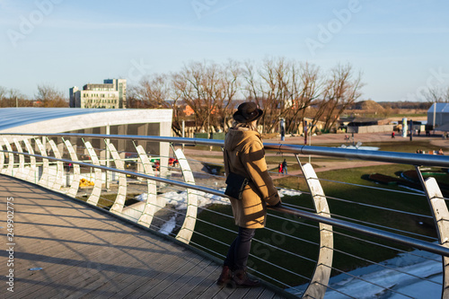 Women enjoys the view from Mitavas bridge over the river Driksa in Jelgava, Latvia photo