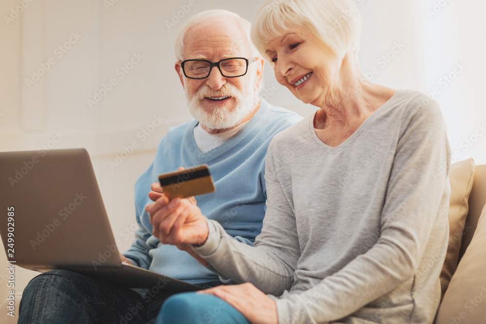 Couple of pensioners taking social card while receiving discounts Couple of pensioners taking social card while receiving discounts