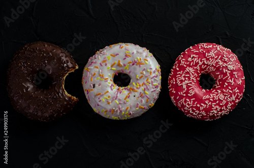 multi-colored donuts on a dark background
