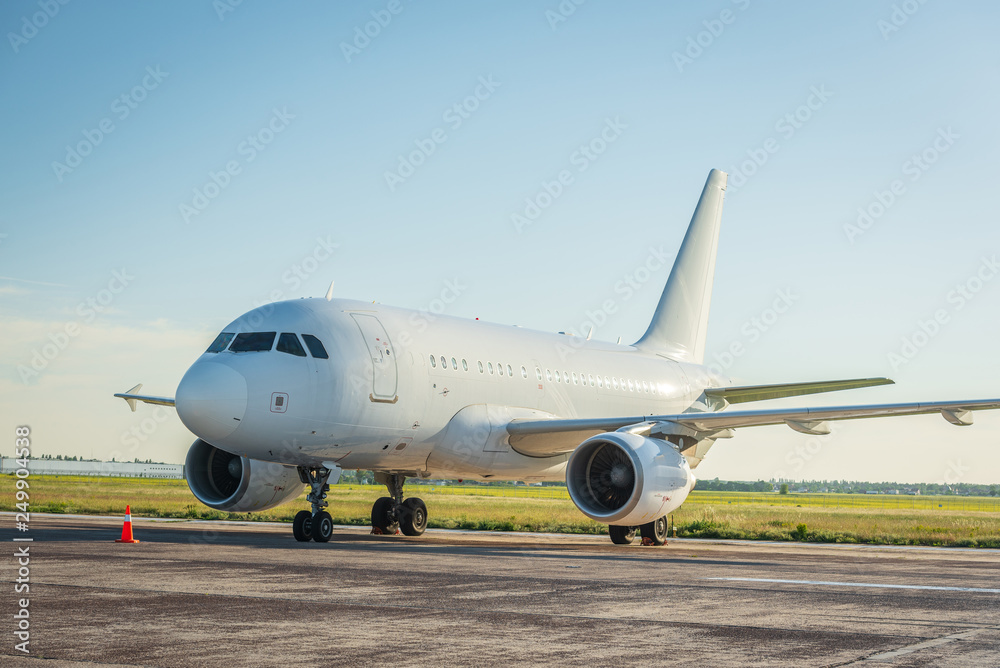 Modern civil passenger airliner is on the airport platform. White aircraft. Vocation and summer travel concept