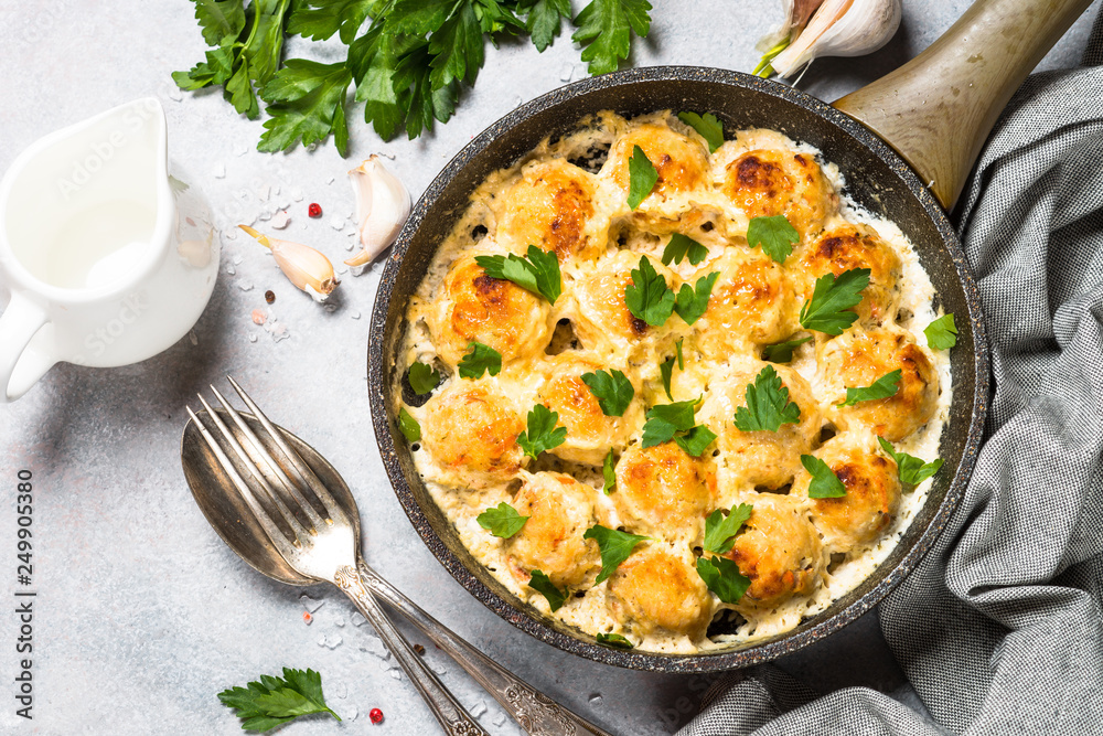 Meatballs in cream sauce with parmesan cheese top view. Meatballs in cream sauce with parmesan cheese top view.