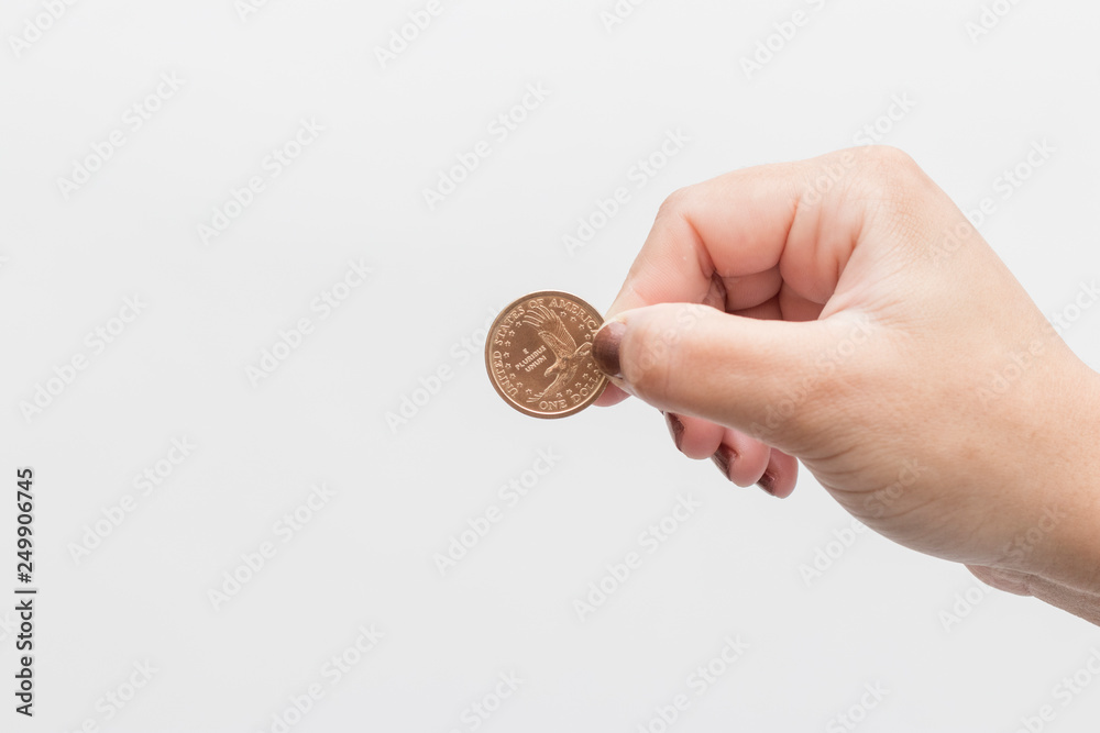 Fototapeta premium woman hand holding 1 dollar coin from Sacagawea
