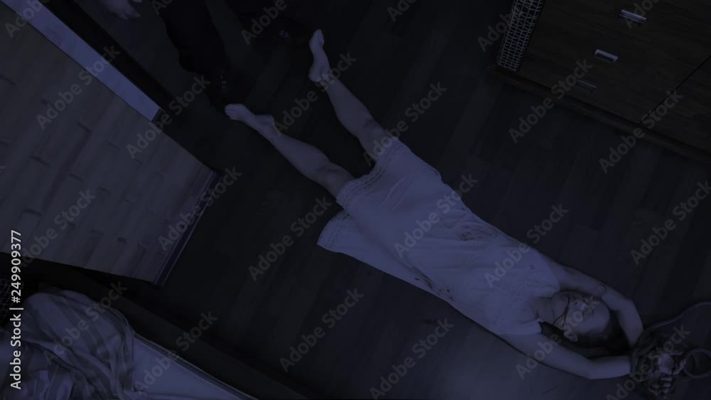 man walks over to bloodied corpse of woman and pulls body out of bedroom. Elimination of traces of crime. Top view.