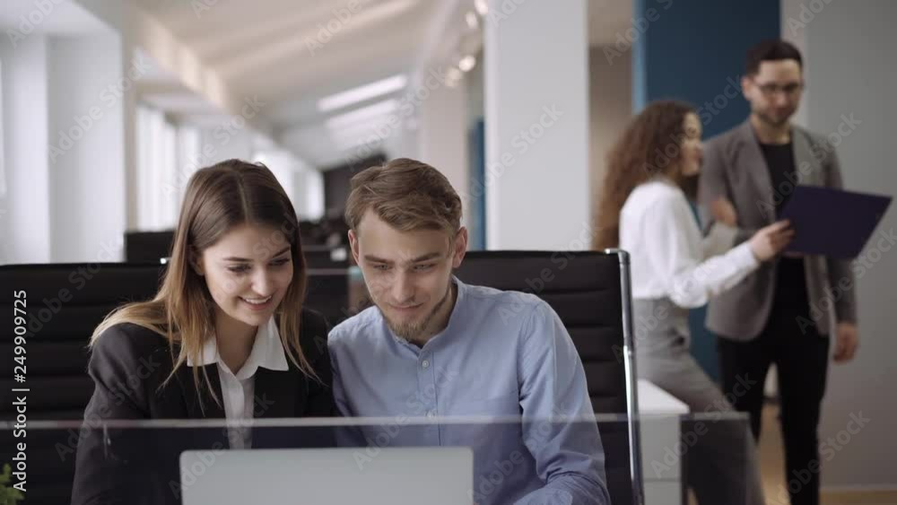 Candid creative busines man and woman discuss project in office