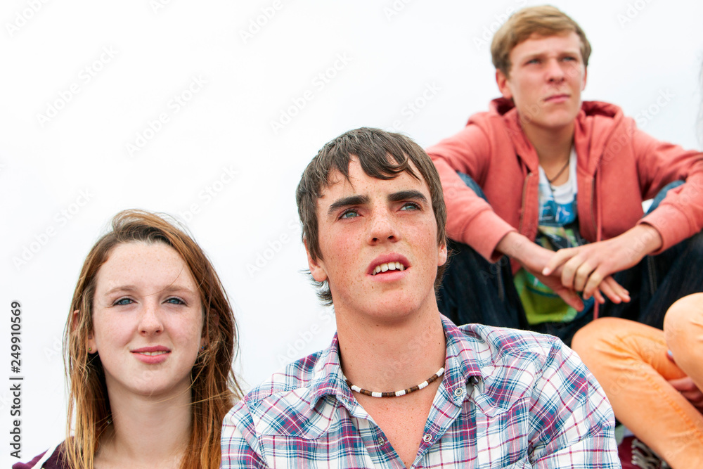 group of teenagers looking away outdoors group of teenagers looking away outdoors