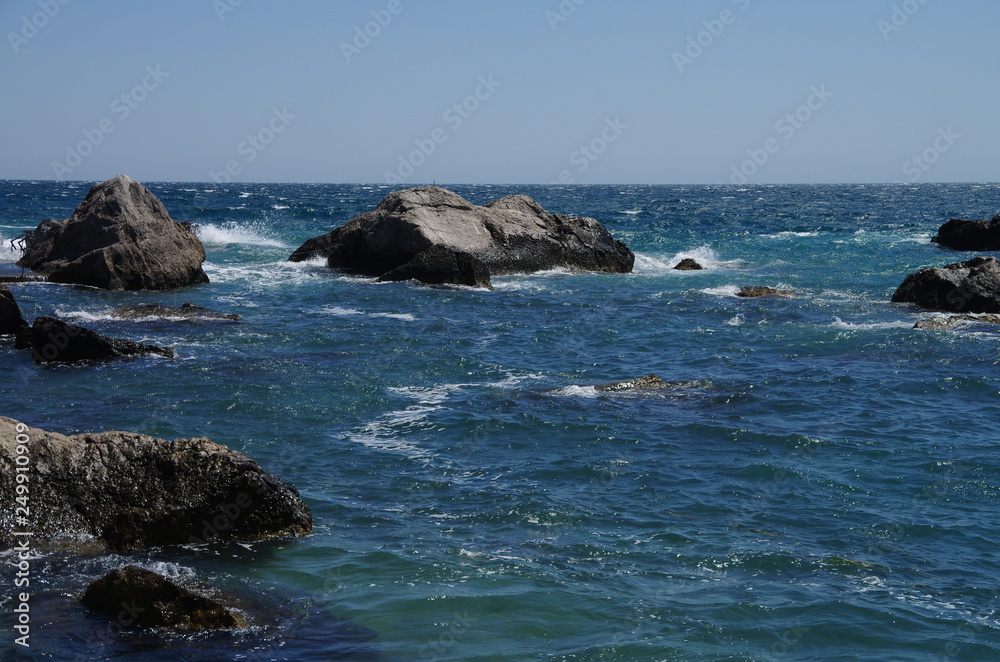 Large stones of frozen lava on the beach in Foros, Crimea. Large stones of frozen lava on the beach in Foros, Crimea.