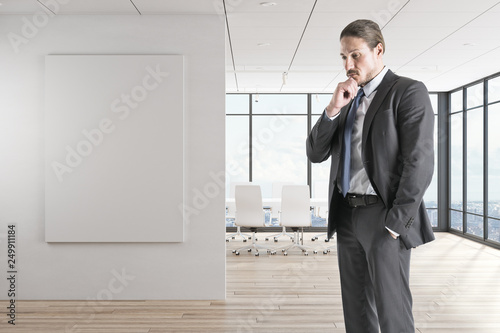 Thoughtful young businessman in office