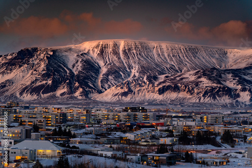 Large mountains rising over Reykjavik City during sunset