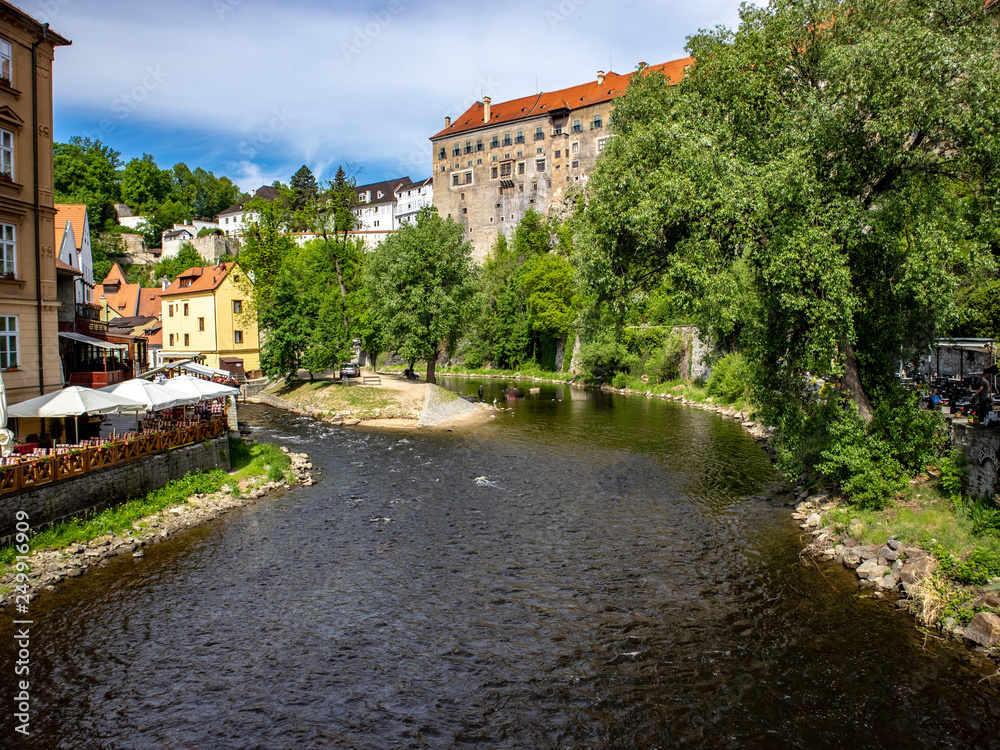 View of the Unesco World Heritage City Český Krumlov in the Czech Republic with historic buildings, churches and narrow streets in front of blue sky