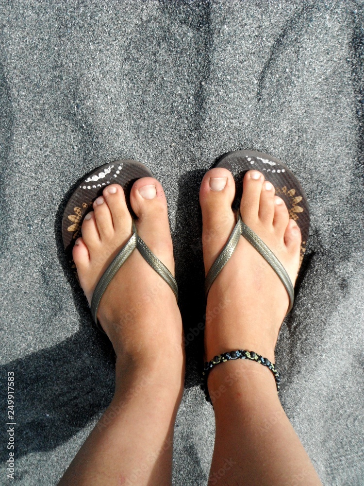 Female Feet in Flip-Flops Standing on Fine Grey Sand at the Beach of  Hokitika, South Island, New Zealand Stock Photo