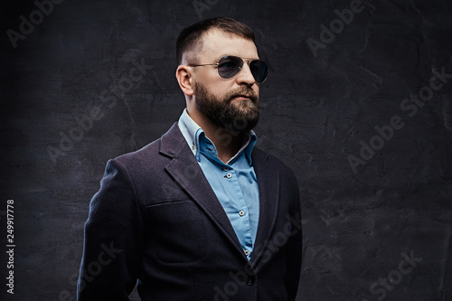 Studio portrait of a successful businessman wearing a suit and sunglasses