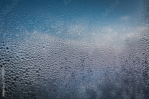 sweaty glass with frozen drops beautiful blue bokeh