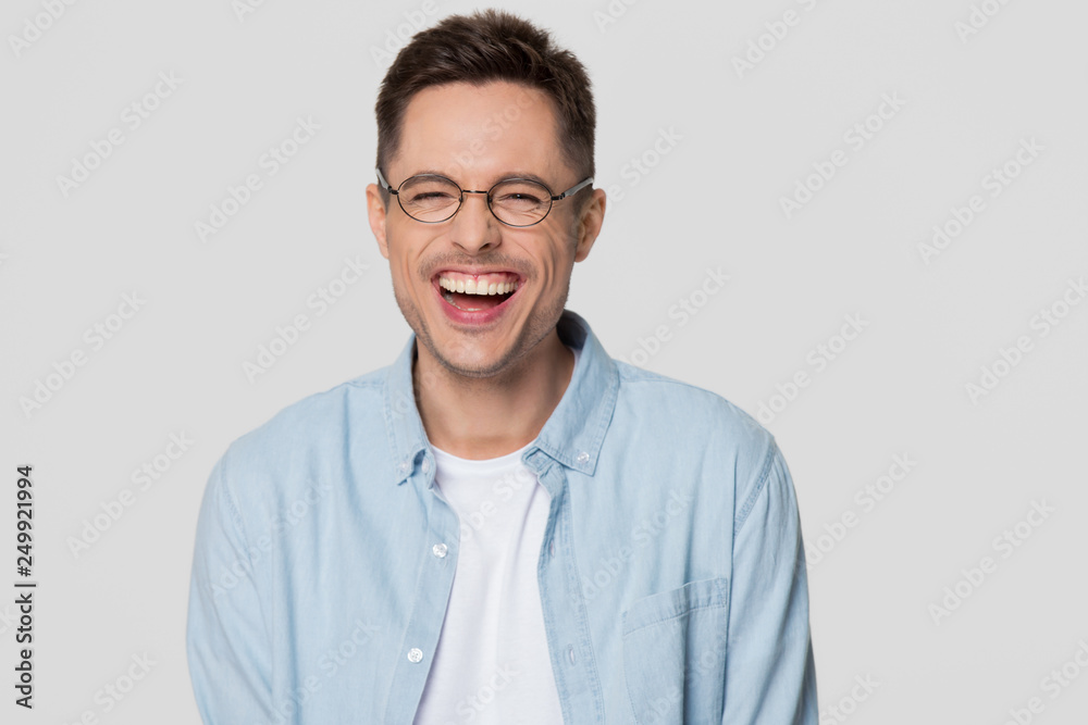Fototapeta premium Funny guy nerd wearing glasses laughing looking at camera