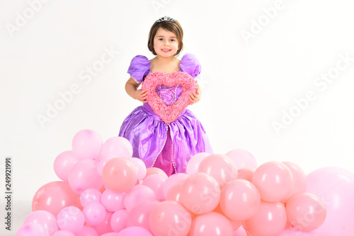 Party balloons. Valentines day. Happy birthday. Kid fashion. Little miss in beautiful dress. Childhood and happiness. Childrens day. Small pretty child hold heart. Little girl princess. True love