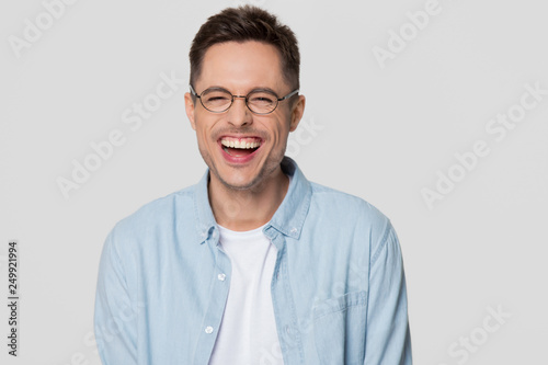 Funny guy nerd wearing glasses laughing looking at camera © fizkes