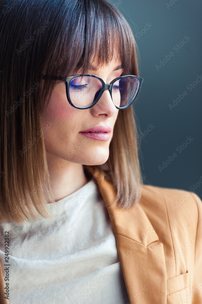 Fototapeta premium Portrait of beautiful young woman in eyeglasses
