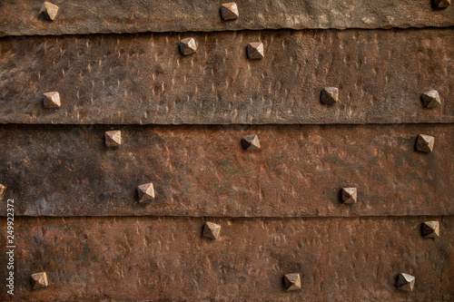Texture of the old gate with metal rivets