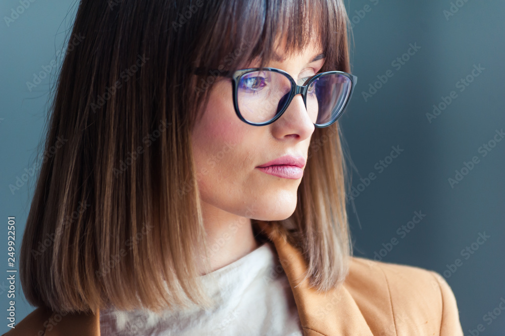 Fototapeta premium Portrait of beautiful young woman in eyeglasses