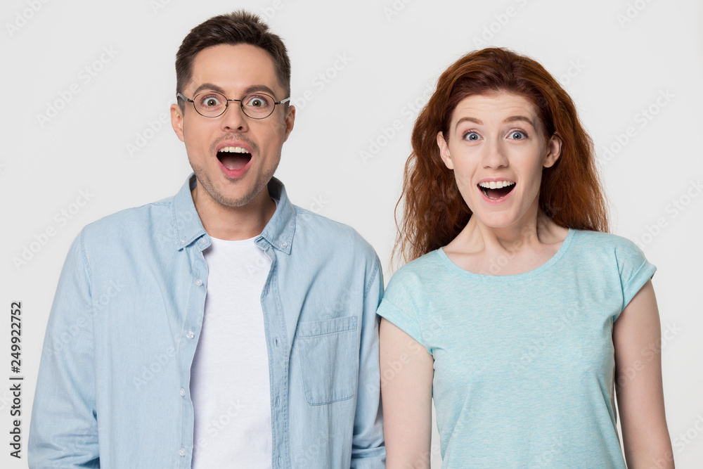 Excited couple with happy faces amazed by unbelievable sale Excited couple with happy faces amazed by unbelievable sale