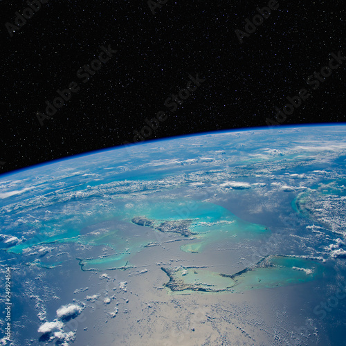 Caribbean seascape from space with stars above. Elements of this image furnished by NASA.