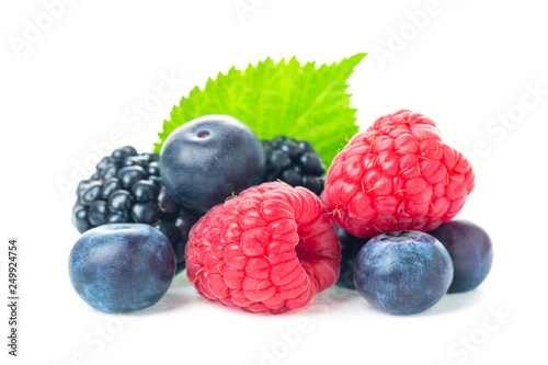 Healthy food berries set. Macro shot of fresh raspberries, blueberries and blackberries with leaf isolated on white background.