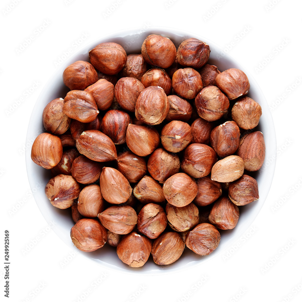 Hazelnuts in bowl isolated on white background Hazelnuts in bowl isolated on white background
