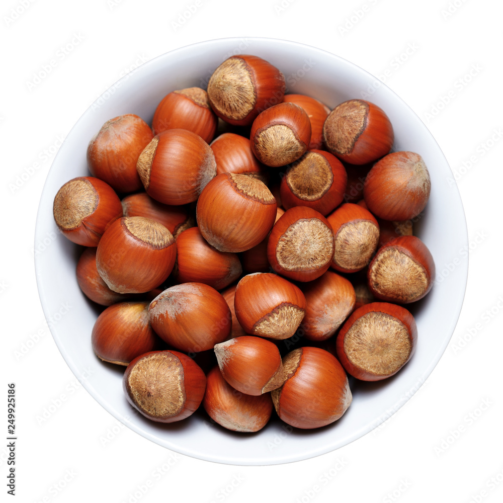 Hazelnuts with shell in bowl isolated on white background Hazelnuts with shell in bowl isolated on white background