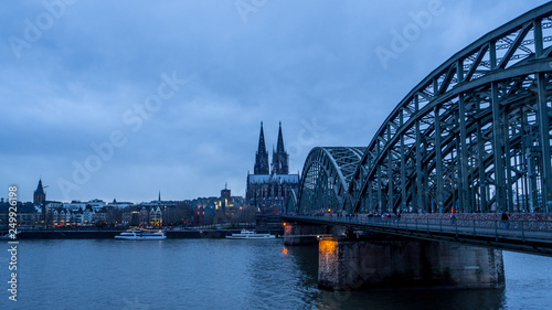 view of river Rhine and city of Cologne at dusk, train bridge and cathedral © luckymi