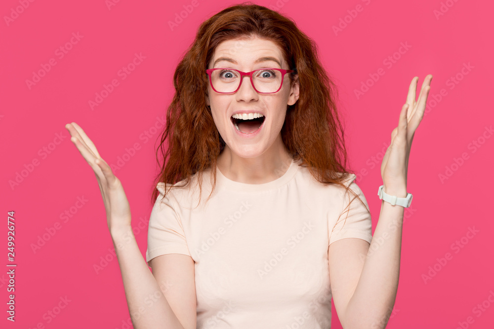 Happy redhead young woman feeling winner isolated on pink background Happy redhead young woman feeling winner isolated on pink background