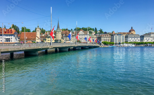 Brücke in Luzern, Schweiz. Flaggen der Schweiz und von Luzern. Im Hintergrund das Stadtbild von Luzern. 