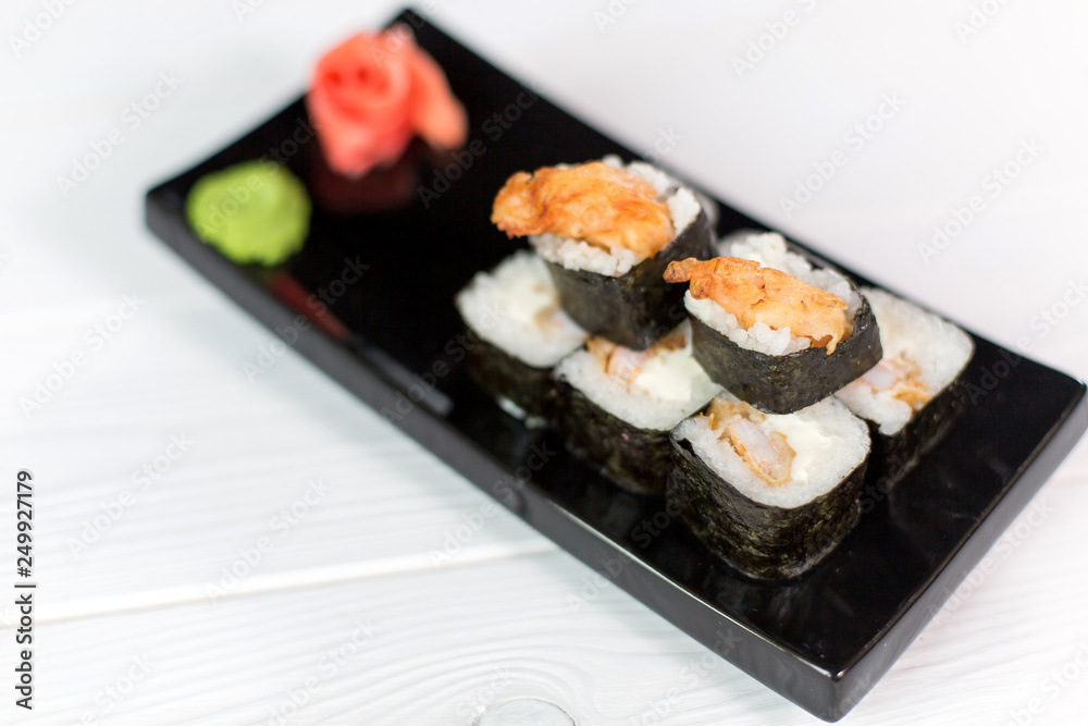Sushi and rolls on black plate. Sea healthy japanese asian food Sushi and rolls on black plate. Sea healthy japanese asian food