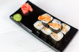 Sushi and rolls on black plate. Sea healthy japanese asian food
