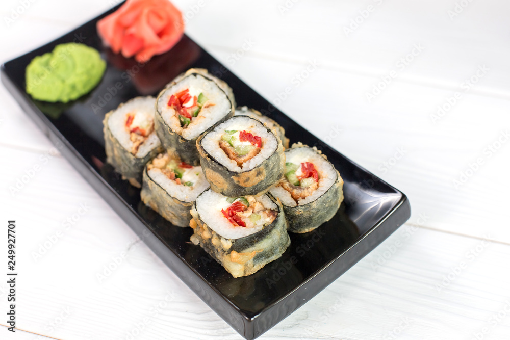 Sushi and rolls on black plate. Sea healthy japanese asian food Sushi and rolls on black plate. Sea healthy japanese asian food
