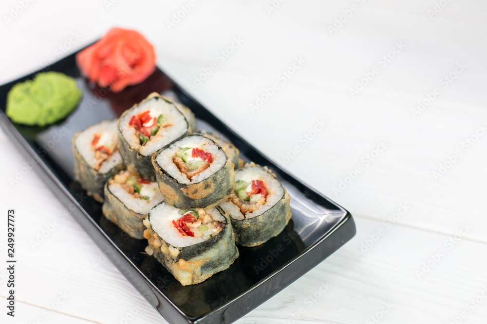 Sushi and rolls on black plate. Sea healthy japanese asian food
