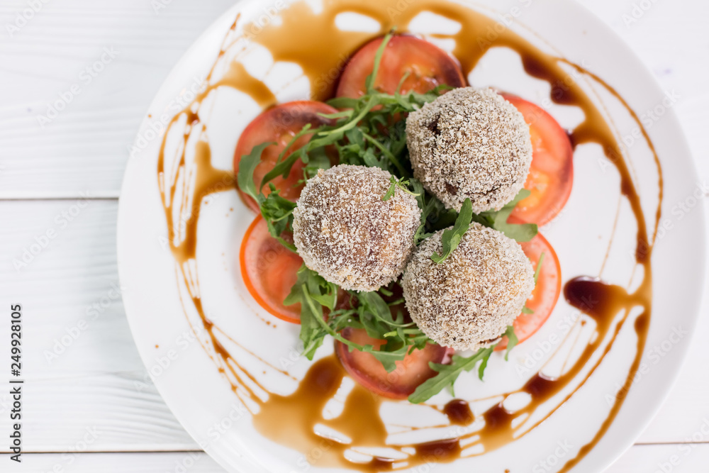 Fresh salat with tomatoes, rucola and meat rolls with sauce Fresh salat with tomatoes, rucola and meat rolls with sauce
