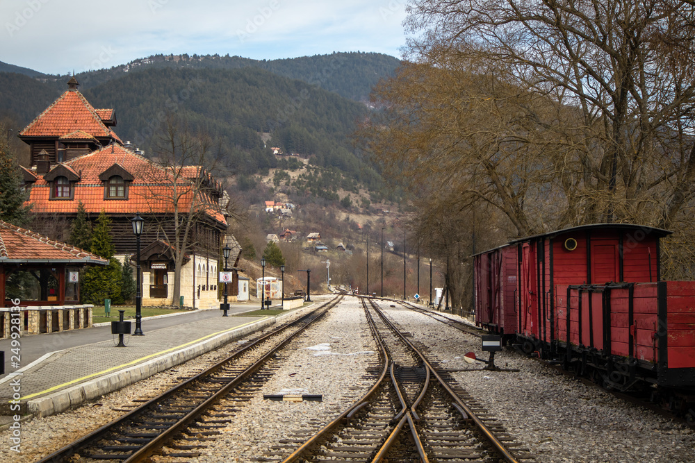 Obraz premium Old railroad station with narrow gauge railway track, popular tourist attraction known as sarganska osmica in Mokra Gora village in Serbia.