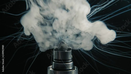 Working electronic cigarette. Macro of coil in RTA, steam in slowmotion. Vape juice explosions