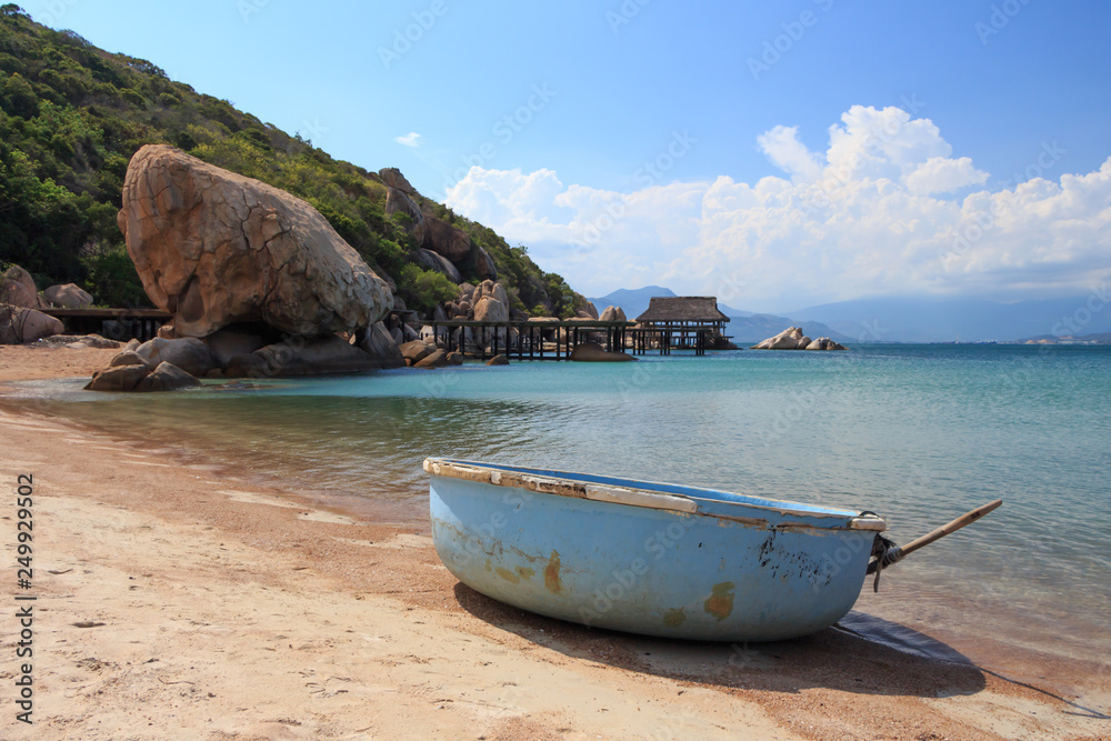 a sandy beach in a sea bay with Vietnamese round boat thung chai a sandy beach in a sea bay with Vietnamese round boat thung chai