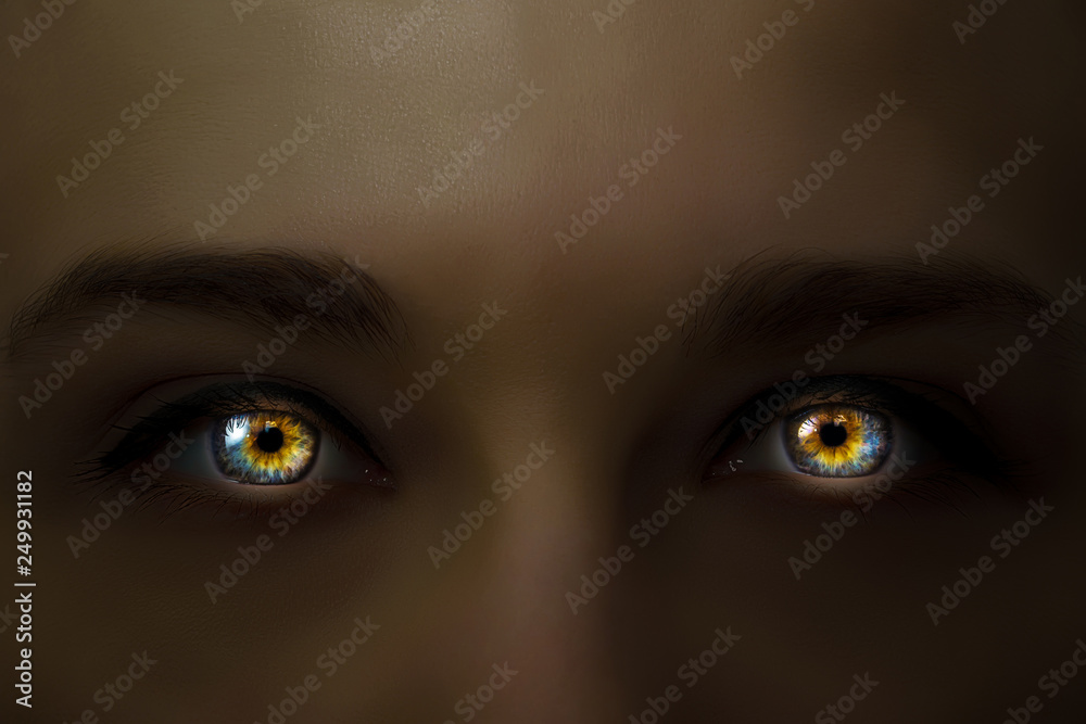 Creative photo of a woman's face with glowing in the dark multi-colored eyes with a mysterious intense look. Glowing in the dark eyes close-up macro.