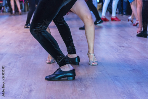 Salsa dance performers on a dance floor, indoor , feet details