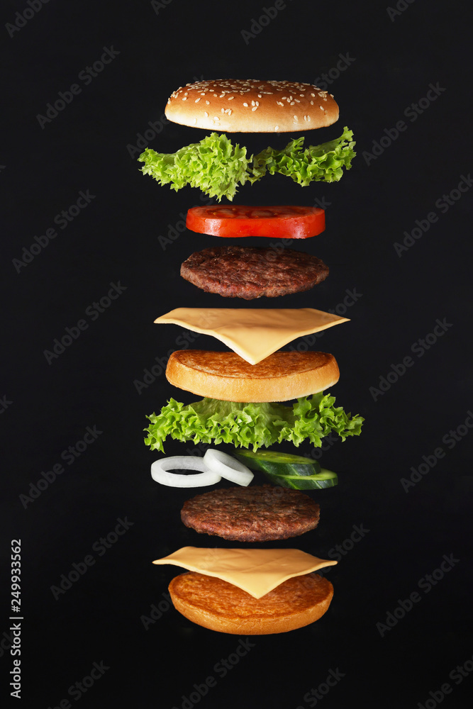 Flying burger ingredients. Delicious hamburger with flying ingredients