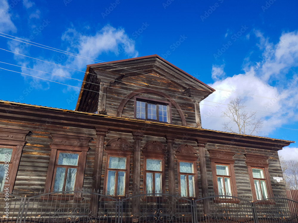 Old wooden house in the city. An old wooden house.