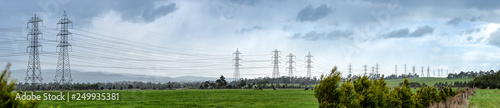 Konstfotografi Panoramic view of powerlines receding into the distance in fields with cattle