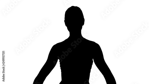 Silhouette Young attractive woman practicing yoga, sitting in Gomukasana exercise, Cow Face pose, while being photographed. photo