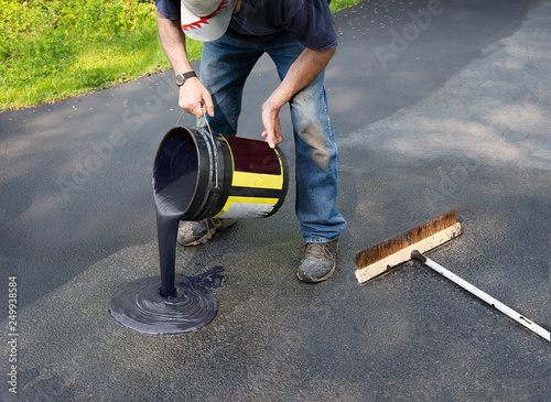 Slika na platnu Pouring asphalt onto driveway for resealing
