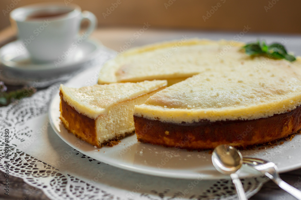 Cheese cake on white plate with mint. Sugar dessert, photo for menu Cheese cake on white plate with mint. Sugar dessert, photo for menu