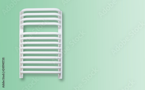 White radiator isolated on a green, pastel background. The concept of heating the apartment, drying clothes. Bright bathroom radiator heating the room.