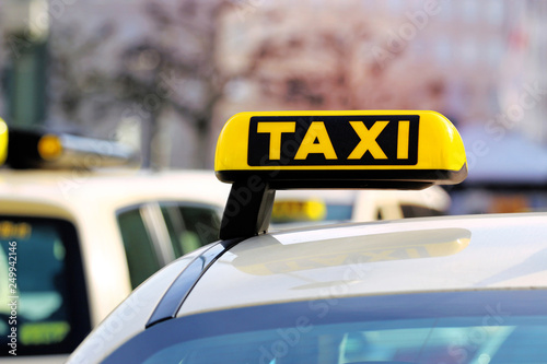 Day picture of a taxi car. Taxi sign on the car roof