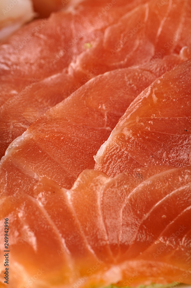 Texture from cold cuts close up. Thin slices of meat, red fish for a snack for a festive table, buffet, party. Fish, meat tartar for a snack, breakfast, lunch, dinner. Texture from cold cuts close up. Thin slices of meat, red fish for a snack for a festive table, buffet, party. Fish, meat tartar for a snack, breakfast, lunch, dinner.