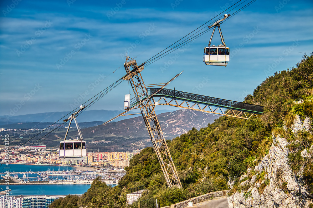Gibraltar cable car descending and climbing to the top of the rock with the  city in the background foto de Stock | Adobe Stock